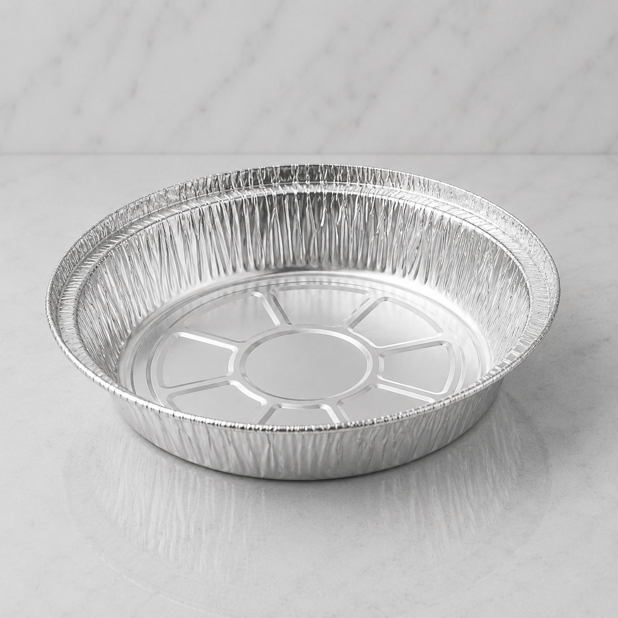 7 inch Aluminum foil pie plate on a gray background