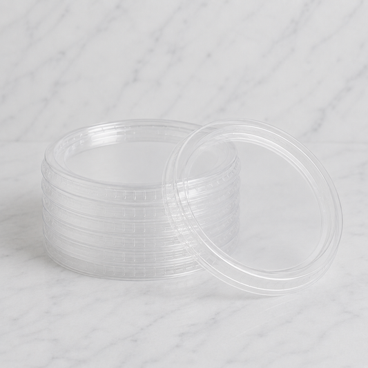 Stack of clear plastic containers with lids on a white background