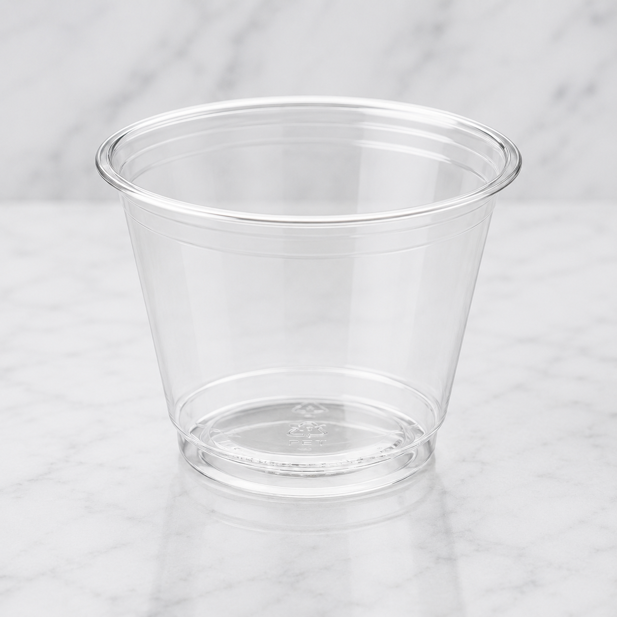 Clear plastic cup on a light gray background