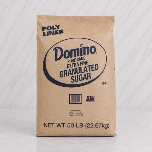 Bag of Domino pure cane extra fine granulated sugar on a white background