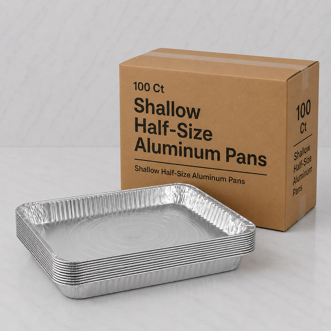 Box of shallow half-size aluminum pans with a single pan in front on a light gray background