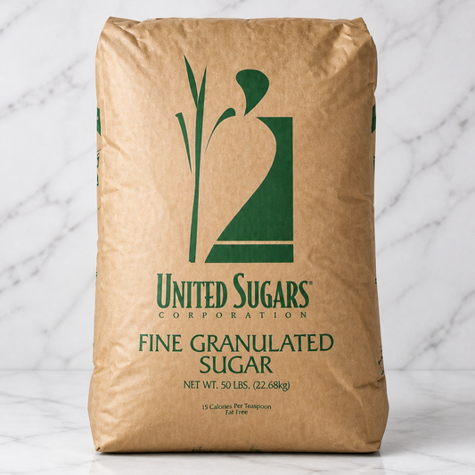 Bag of United Sugars Corporation fine granulated sugar on a marble surface